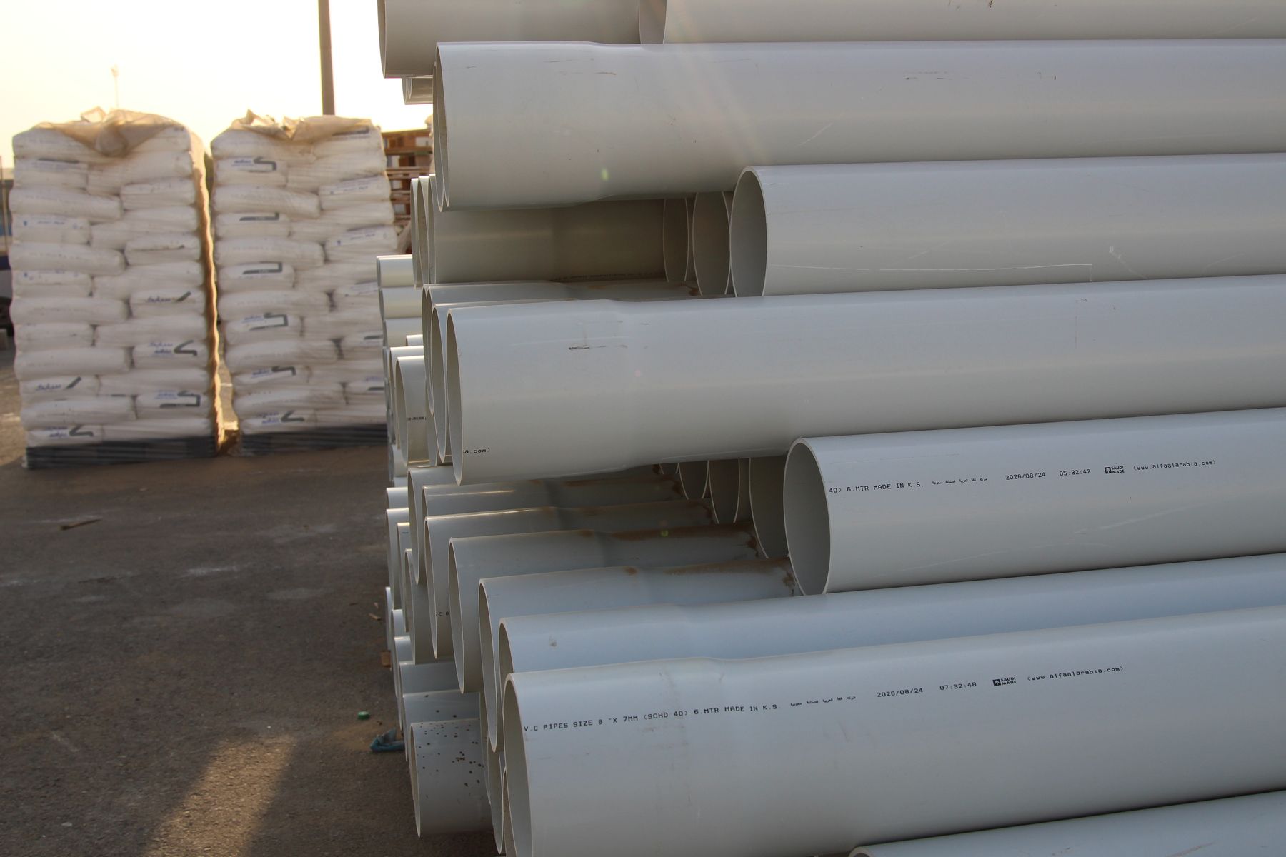 ALFA uPVC pipes stacked in yard — Made in K.S.A.